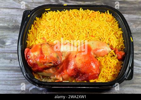 Chicken mandi kabsa with long basmati rice, usually served with tomato dakos sauce, green salad and tahini, Yemen recipe of Yemeni Mandi chicken and r Stock Photo