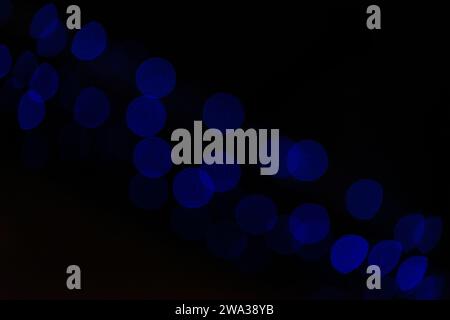Abstract defocused overlay background. Red bokeh lights on black background Stock Photo