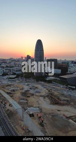 Aerial drone footage of Torre Agbar Barcelona Spain iconic bullet-shaped modern skyscraper landmark Jean Nouvel architecture Stock Photo