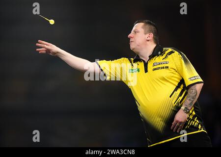 Dave Chisnall in action against Luke Humphries (not pictured) on day fourteen of the Paddy Power World Darts Championship at Alexandra Palace, London. Picture date: Monday January 1, 2024. Stock Photo