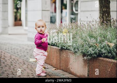 Adorable baby girl of 9-12 months old playing outside Stock Photo