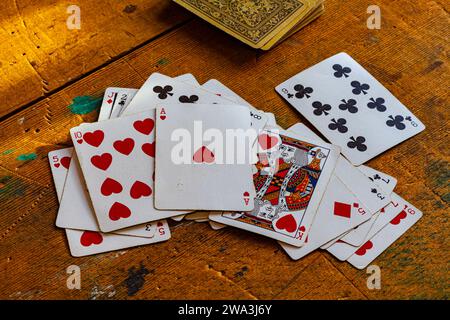 Antique playing cards on an old kitchen table at the Britannia Ship Yard in Steveston Canada Stock Photo