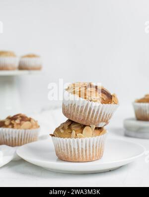 almond muffins on a white plate, homemade bakery style almond muffins on a white background Stock Photo