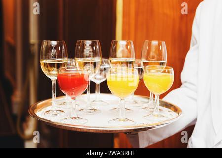 Waiter carrying tray with drinks on some festive event, party or wedding reception Stock Photo