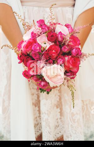 Tender bouquet of pink roses and light lavender in bride's hands Stock Photo