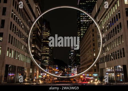 Gigantic Ring at night at Esplanade Place Ville Marie in downtown Montreal, Quebec, Canada Stock Photo
