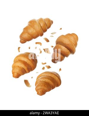 Delicious fresh croissants falling on white background Stock Photo