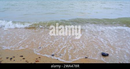 Natural View Of Sea Waves Breaking On The Edge Of A Yellow Sandy Beach, On Tanjung Kalian, Indonesia Stock Photo