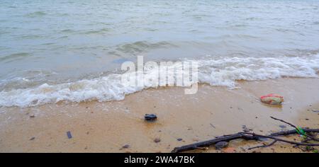 A Natural View Of The Foamy Sea Waves Breaking On The Shore Of Tanjung Kalian, Indonesia Stock Photo