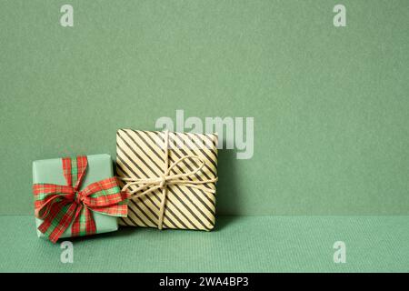 Gift boxes on table. green wall background. copy space Stock Photo