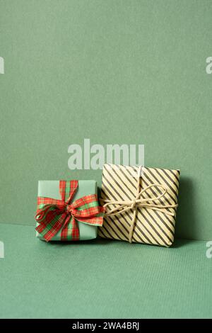 Gift boxes on table. green wall background. copy space Stock Photo