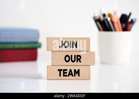 The message join our team on wooden blocks. Business employment and recruitment offer. Stock Photo