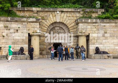 Pyatigorsk, Russia - May 12, 2023: Tourists at the entrance of Proval, it is a natural well of karst-tectonic origin on the southern slope of Mount Ma Stock Photo