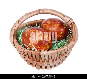 Two Easter eggs in a homemade basket  isolated macro Stock Photo