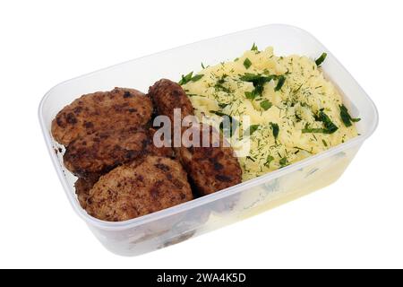 Homemade minced pork cutlets and mashed potatoes in a plastic container. Isolated on white Stock Photo