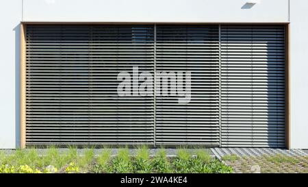 The large window of a modern school is protected from the  sun by blinds Stock Photo