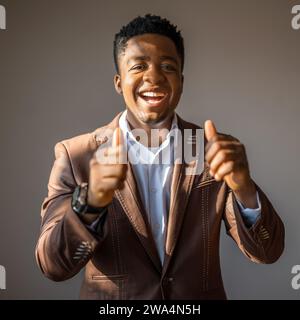 Portrait of happy businessman who is smiling and showing thumbs up. Stock Photo