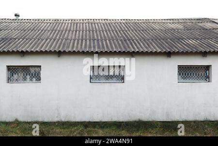 The windows of a rustic barn are protected by iron bars. Isolated Stock Photo