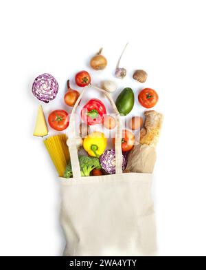 Eco friendly fabric bag filled with fresh colorful vegetables, pasta, baguette, mushrooms and cheese on a white background. Reduse plastic polution by Stock Photo