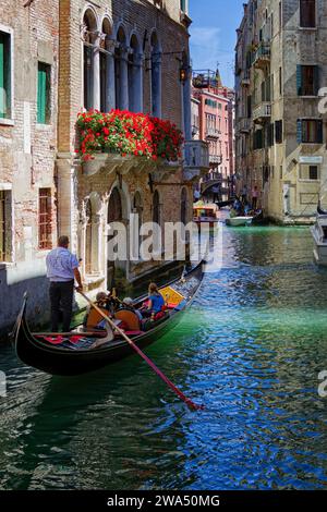 Gondola on a narrow canal in Venice Italy Europe Stock Photo