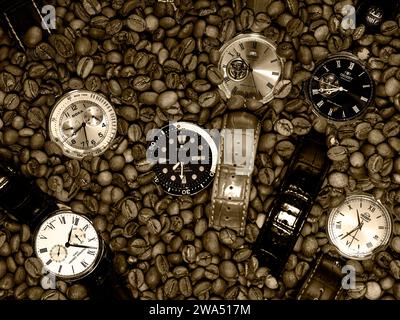 Coffee time - six wrist watches and coffee beans on a table Stock Photo