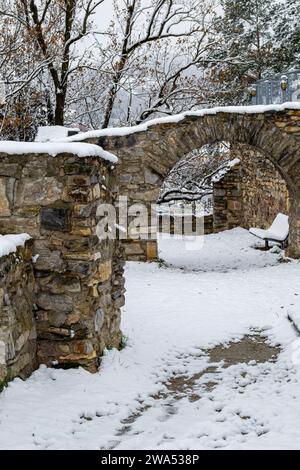 The ruins of an ancient castle covered with the first white snow Stock Photo