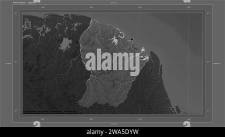 French Guiana highlighted on a Grayscale elevation map with lakes and rivers map with the country's capital point, cartographic grid, distance scale a Stock Photo