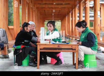 Beijing, China's Guizhou Province. 2nd Jan, 2024. A family doctor measures a villager's blood pressure in Gangbian Village of Congjiang County, southwest China's Guizhou Province, Jan. 2, 2024. Workers around China have returned to their respective posts after the New Year holiday. Credit: Luo Jinglai/Xinhua/Alamy Live News Stock Photo