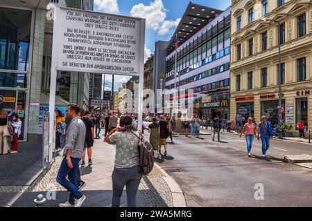 Berlin, Germany - August 4, 2021: People at Friedrichstraße next to famous Checkpoint Charlie in the city center. Stock Photo