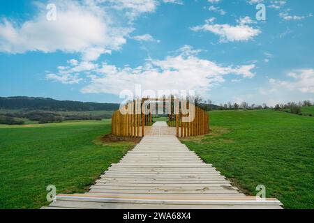 Green meadow with wooden walkway and wooden circular landscape. Fairy Mountain National Forest Park, Wulong County, Chongqing, China. Stock Photo