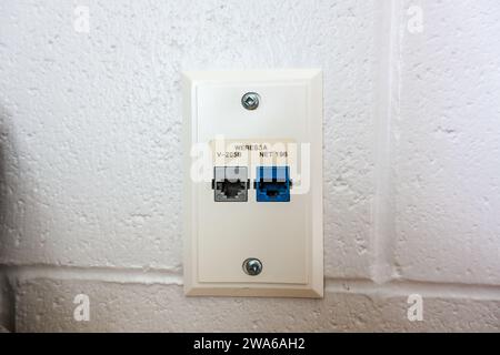 Internet LAN Local Access Network cable plug in point on wall Stock Photo