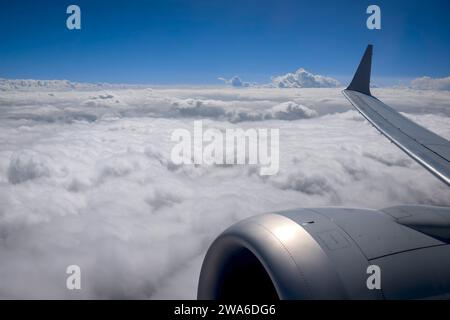 Clouds from above with plane engine and wing Stock Photo