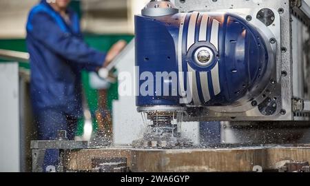 vertical milling machine close-up processes a part in production, modern equipment for metal processing Stock Photo