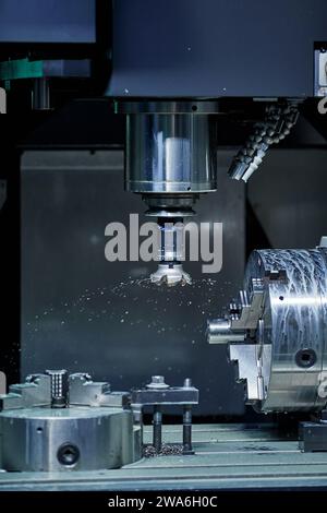 vertical milling machine close-up processes a part in production, modern equipment for metal processing Stock Photo
