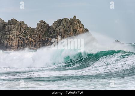 High winds and big waves during Storm Gerrit at Porthcurno beach, Cornwall, UK. The Logan Rock is in the background Stock Photo
