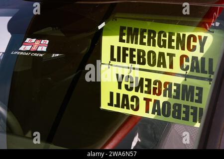 RNLI Lifeboat Crew Windscreen Sticker And Emergency Lifeboat Call Sign Hanging In The Windscreen Of A Car At Mudeford Lifeboat Station Stock Photo