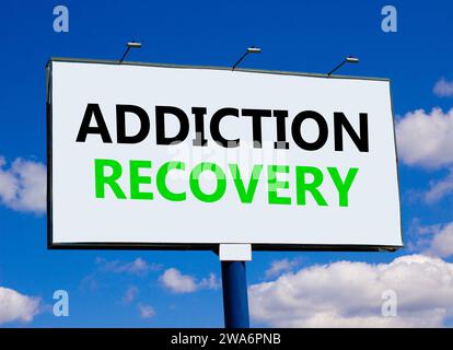 Addiction recovery symbol. Concept words Addiction recovery on beautiful white billboard. Beautiful blue sky white cloud background. Psychology addict Stock Photo