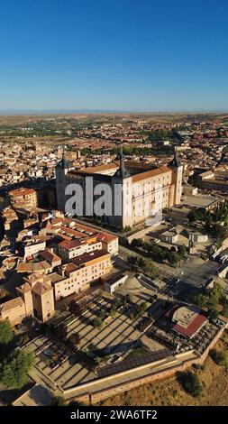 Aerial drone footage of Alcázar de Toledo Spain iconic 16th-century stone fortress four corner towers hilltop city skyline and Tagus River valley Stock Photo