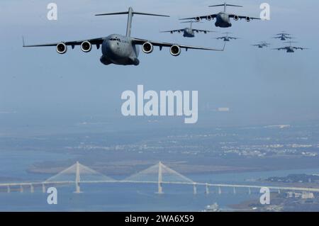 US military forces. C-17s from Charleston AFB fly over the Arthur Ravenel Jr. Bridge Dec. 18. C-17s from the 437th and 315th Airlift Wings dropped cargo at a remote airfield during a strategic brigade airdrop exercise involving a 13-ship formation.  This multi-ship training demonstrates the teamwork of active-duty Airmen, Reservists and civilians to be mission-ready when the nation needs this critical capability. (U.S. Air Force photo/Staff Sgt. Richard Rose) Stock Photo