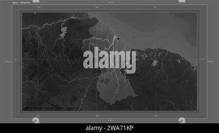 Guyana highlighted on a Grayscale elevation map with lakes and rivers map with the country's capital point, cartographic grid, distance scale and map Stock Photo