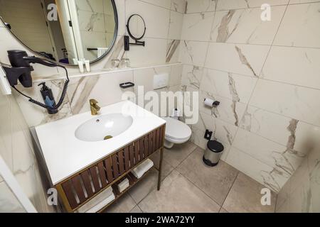 Beautiful interior view of the hotel's restroom in light tones with all amenities for guests. Curacao. Stock Photo