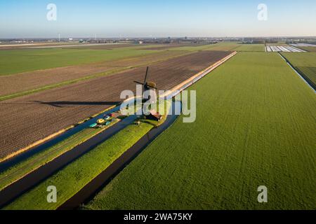 dutch windmill on a field in the countryside Stock Photo