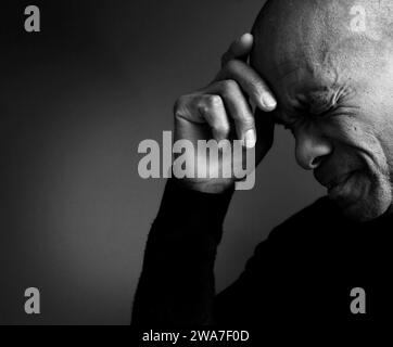 man praying to god with hands together Caribbean man praying with black background with people stock photo Stock Photo