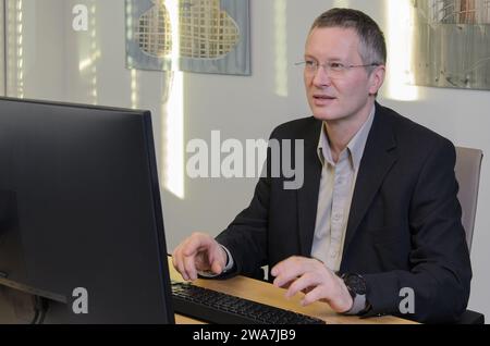 man works at computer in IT office Stock Photo