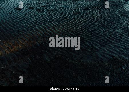 sand waves, dark blue ripples in sand on Pacific Northwest beach Stock Photo