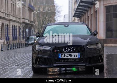 Nancy, France - Black Audi RS6 Avant C7 parked in a street under the rain. Stock Photo