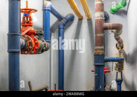 The interior of a mechanical room and a domestic potable water system with valves and connecting pipes. Stock Photo