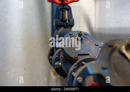 The interior of a mechanical room and a domestic potable water system with valves and connecting pipes. Stock Photo