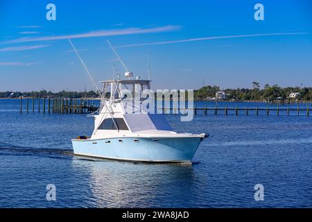 A fishing boat gracefully returns to port, carrying the echoes of a day's adventure on the Gulf of Mexico. Stock Photo