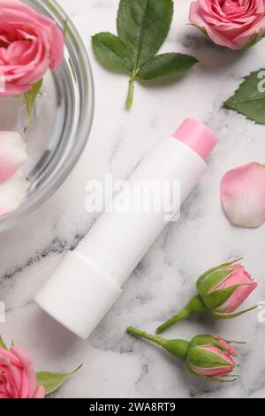 Flat lay composition with lip balm on white marble background Stock Photo